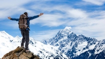 Hiker spreading arms on a mountain top Hiker spreading arms on a mountain top