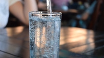 A glass of sparkling mineral water on a table