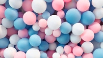 A large number of balloons in white, blue and pink