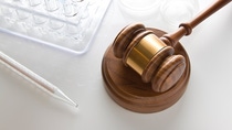 Laboratory Equipment on reflective surface with gavel Laboratory Equipment on reflective surface with gavel