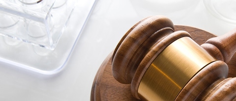 Laboratory Equipment on reflective surface with gavel Laboratory Equipment on reflective surface with gavel