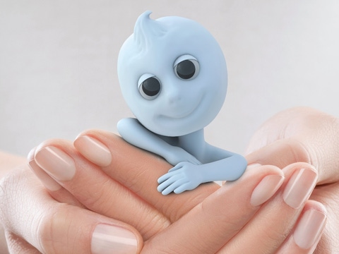 Dinchy, a little blue figure, smiling, being cradled by a womens hands. Dinchy, a little blue figure, smiling, being cradled by a womens hands.