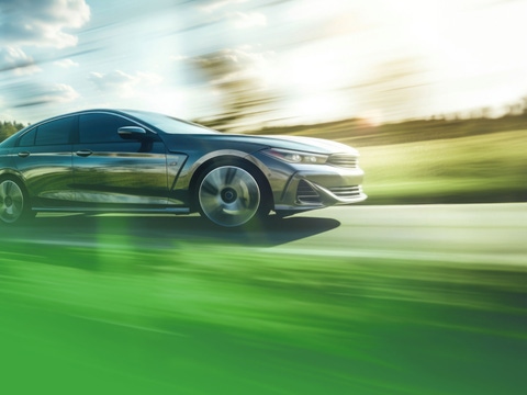 Car with AdBlue® ZeroPCF by BASF is driving through landscape