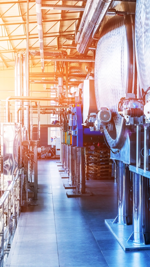 Interior of chemical factory or plant workshop with metal industrial manufacturing production equipment