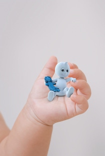 Dinchy, the brand ambassador for Hexamoll DINCH, playing with a toy doll