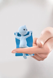 Dinchy, the brand ambassador for Hexamoll DINCH, sitting on a hand and holding a wallpaper.